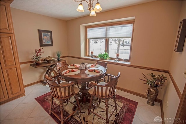1250 Yankee Woods Dr, Washington Twp, OH 45458 - dining room with light tile patterned floors, a chandelier, and baseboards