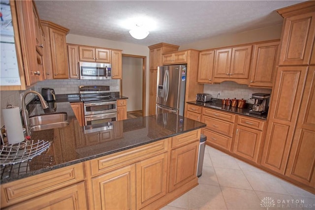 1250 Yankee Woods Dr, Washington Twp, OH 45458 - kitchen with stainless steel appliances, a sink, tasteful backsplash, a peninsula, and dark stone countertops