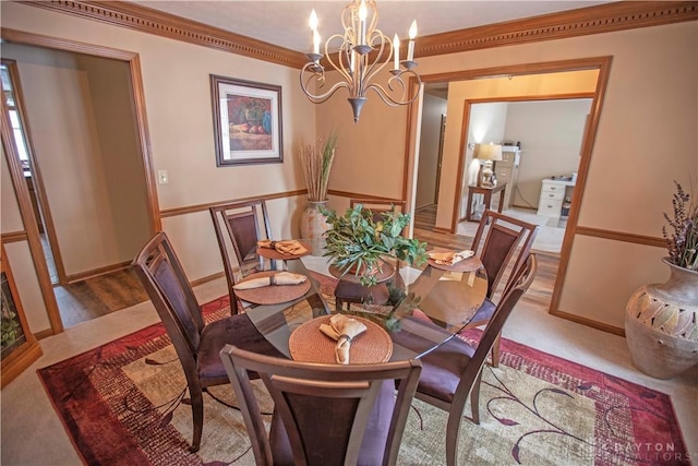 dining area with an inviting chandelier and ornamental molding