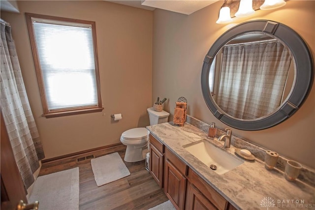 1250 Yankee Woods Dr, Washington Twp, OH 45458 - bathroom featuring wood finished floors, vanity, toilet, and healthy amount of natural light