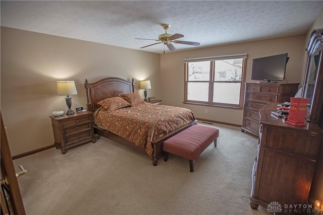 bedroom featuring light carpet, a textured ceiling, a ceiling fan, and baseboards