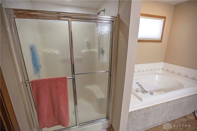 1250 Yankee Woods Dr, Washington Twp, OH 45458 - full bathroom featuring a shower stall, a garden tub, and wood finished floors