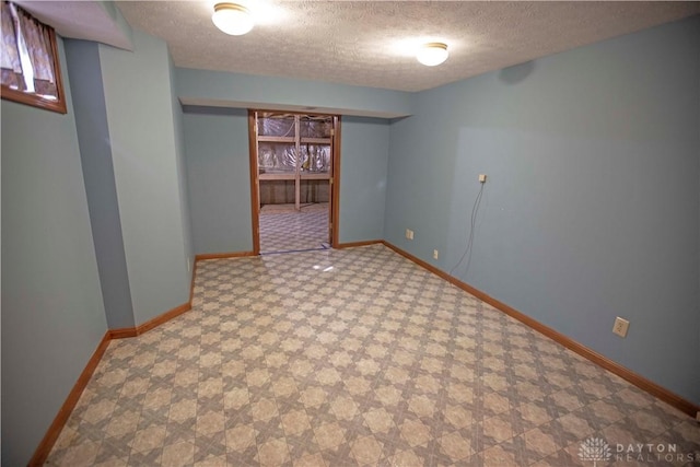 1250 Yankee Woods Dr, Washington Twp, OH 45458 - finished below grade area with a textured ceiling, baseboards, and tile patterned floors