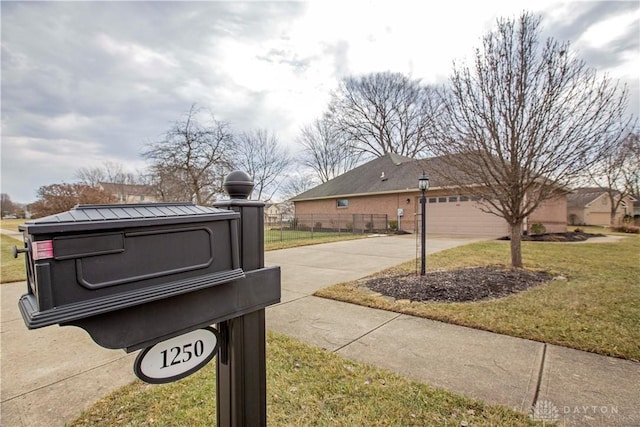 exterior space featuring driveway and fence