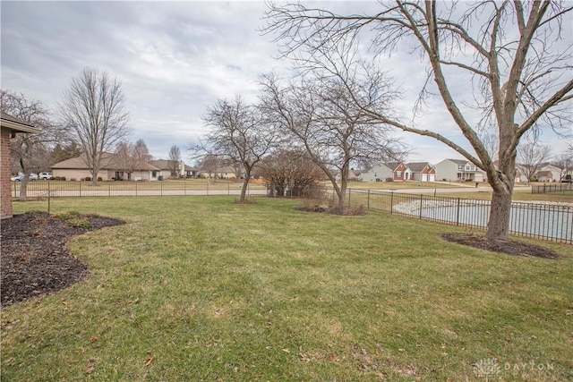 view of yard with a residential view and fence