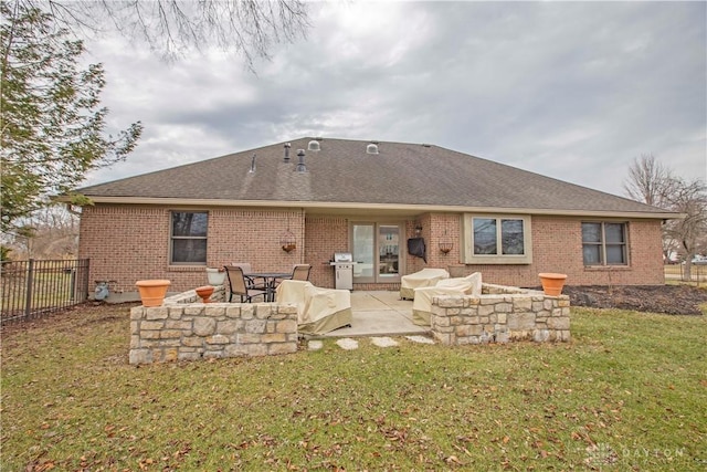 back of house with a yard, a patio area, fence, and brick siding