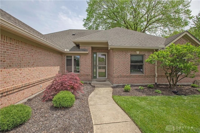 1250 Yankee Woods Dr, Washington Twp, OH 45458 - entrance to property featuring roof with shingles, brick siding, and a lawn