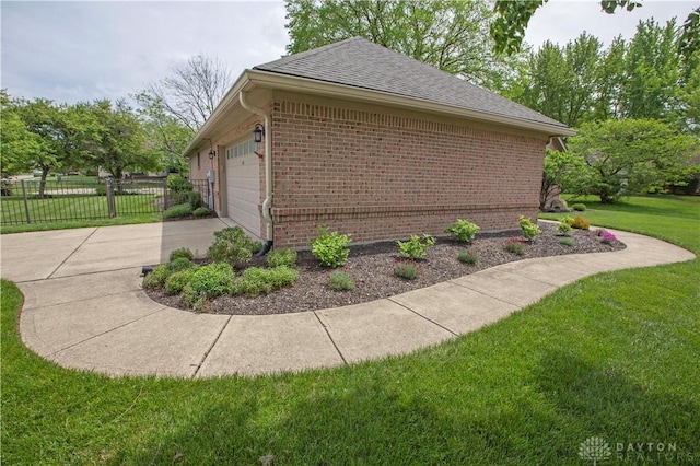 1250 Yankee Woods Dr, Washington Twp, OH 45458 - view of home's exterior featuring brick siding, concrete driveway, roof with shingles, and a garage