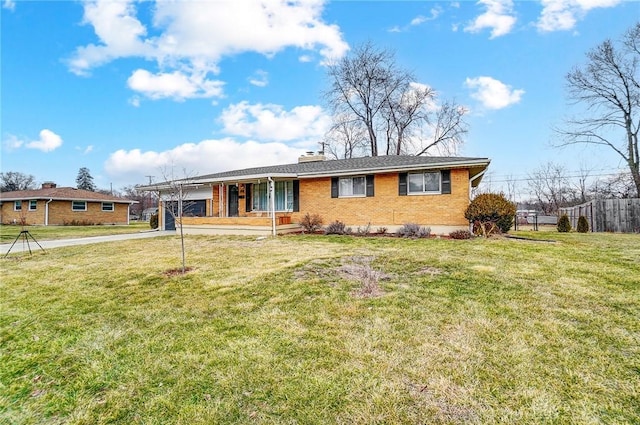 single story home featuring driveway, brick siding, a chimney, a carport, and a front yard