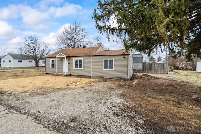 ranch-style home featuring fence