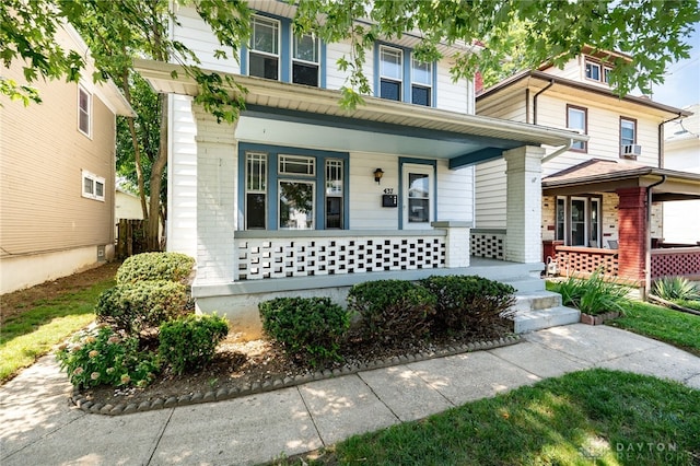 view of front of home with a porch and brick siding