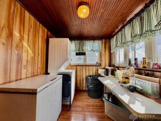 kitchen featuring wooden ceiling, wooden walls, and wood finished floors