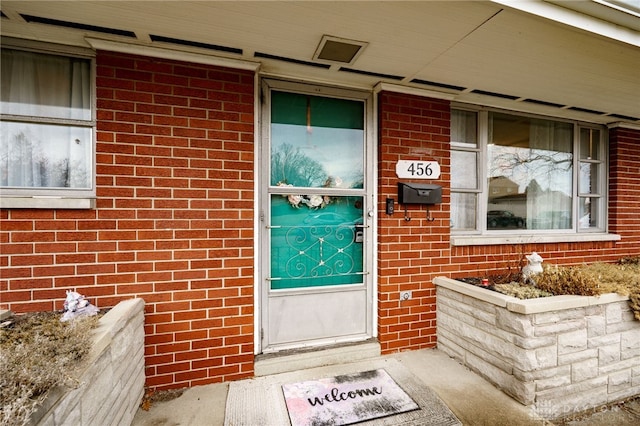 property entrance with brick siding