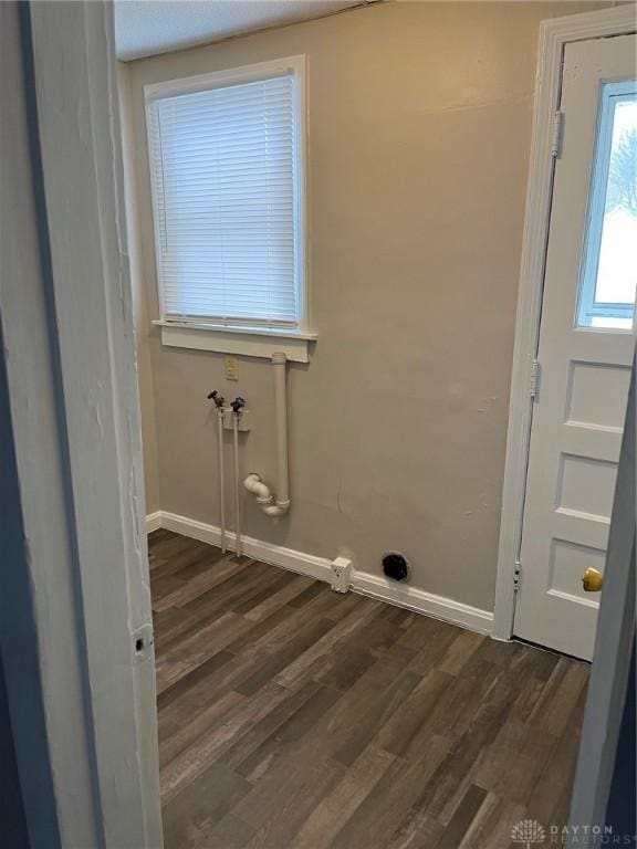 laundry area featuring dark wood-style floors, laundry area, hookup for a washing machine, and baseboards