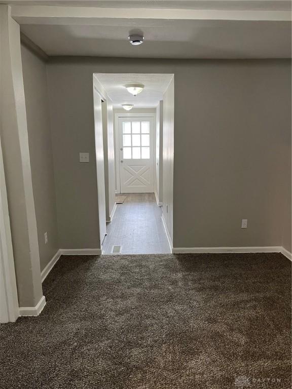 interior space with carpet flooring and baseboards