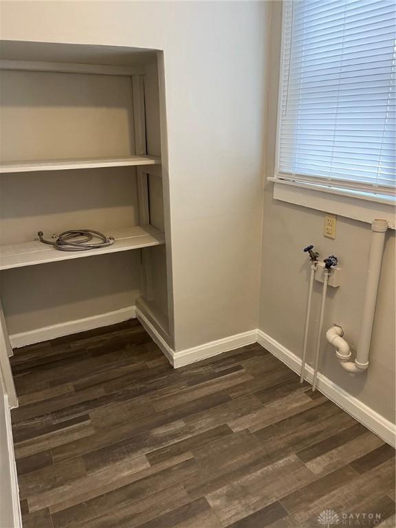 interior space with wood finished floors and baseboards