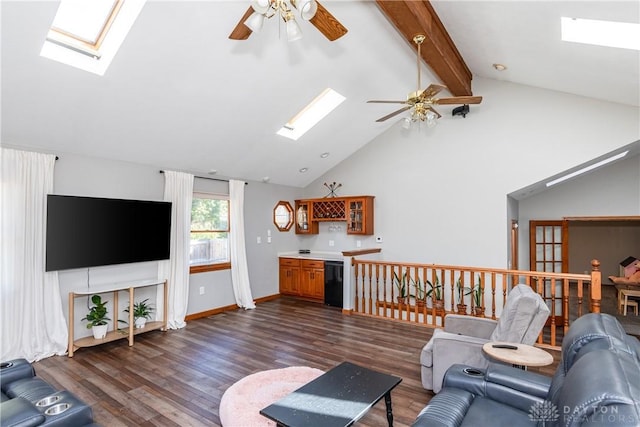 living room featuring a skylight, ceiling fan, dark wood finished floors, and beamed ceiling