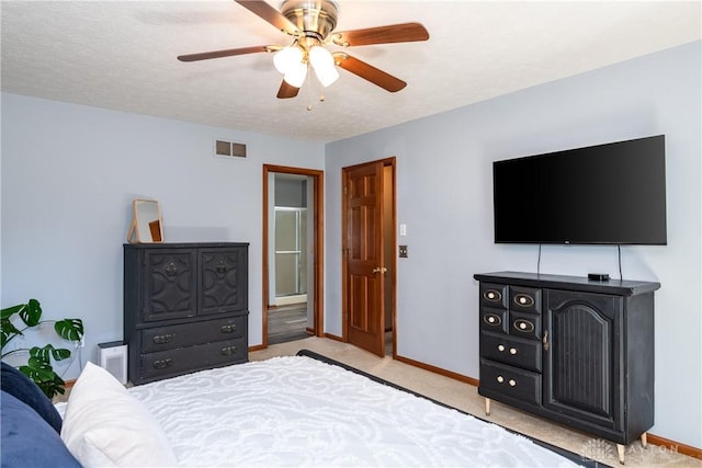 carpeted bedroom with baseboards, visible vents, ceiling fan, and a textured ceiling