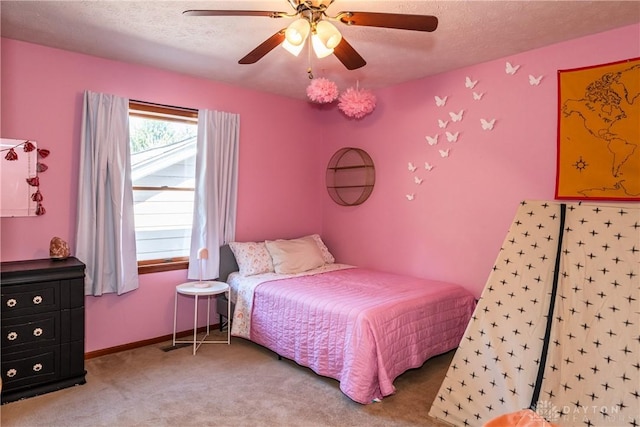 carpeted bedroom featuring a ceiling fan, a textured ceiling, and baseboards