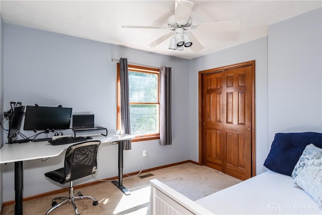 bedroom with light carpet, ceiling fan, and baseboards