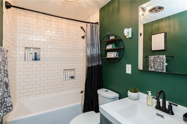 bathroom with shower / tub combo with curtain, vanity, toilet, and a textured ceiling