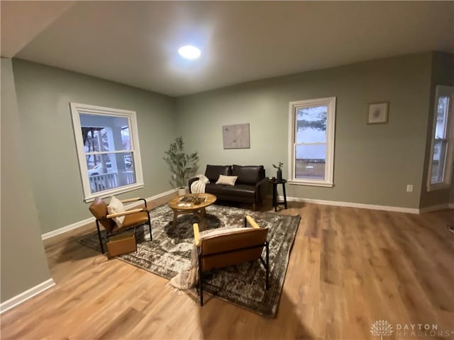 living area with wood finished floors and baseboards