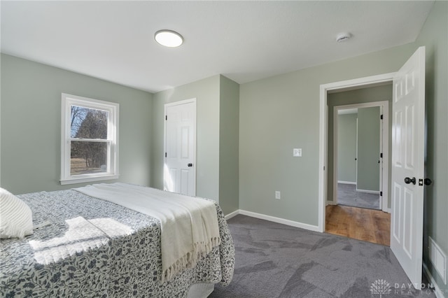 bedroom featuring carpet and baseboards