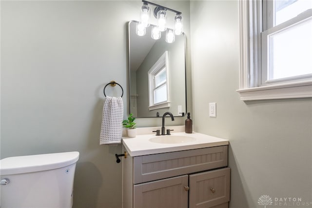 half bathroom with toilet and vanity