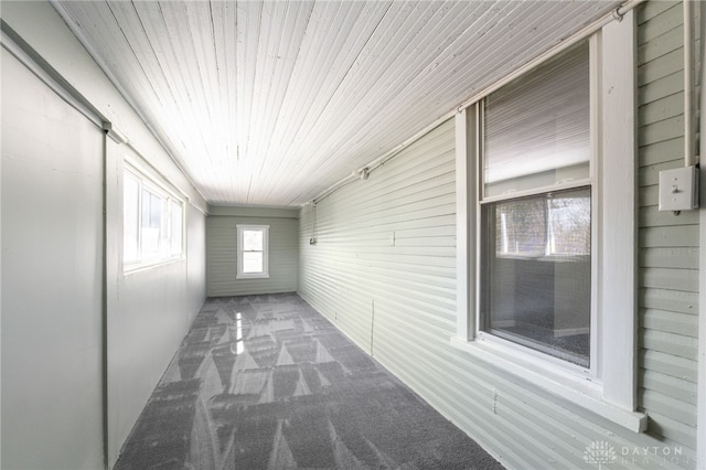 unfurnished sunroom with wood ceiling