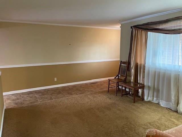 unfurnished room featuring baseboards, crown molding, and carpet flooring