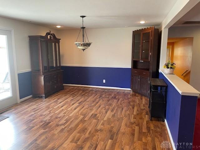 interior space with recessed lighting, wood finished floors, and baseboards