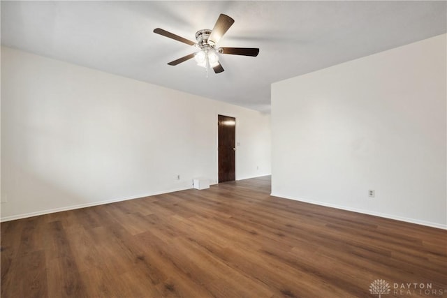 unfurnished room with baseboards, a ceiling fan, and wood finished floors