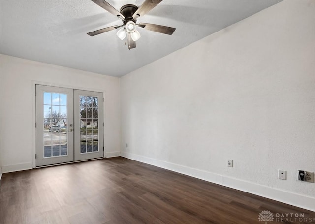 empty room with ceiling fan, baseboards, dark wood-style flooring, and french doors