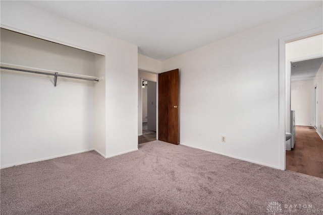 unfurnished bedroom with carpet and a closet