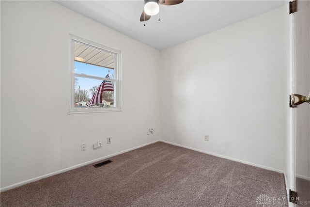 carpeted empty room featuring visible vents, ceiling fan, and baseboards