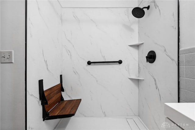 bathroom with a marble finish shower