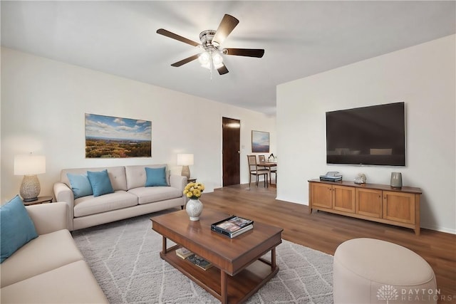 living area featuring a ceiling fan and wood finished floors