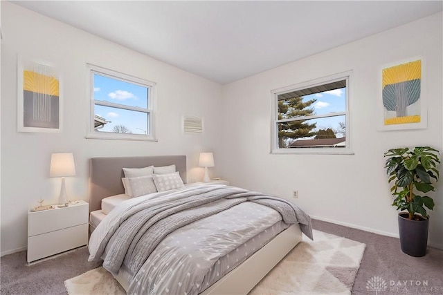 bedroom featuring carpet and baseboards