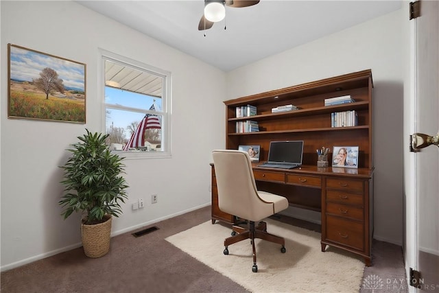 office area with light carpet, ceiling fan, visible vents, and baseboards