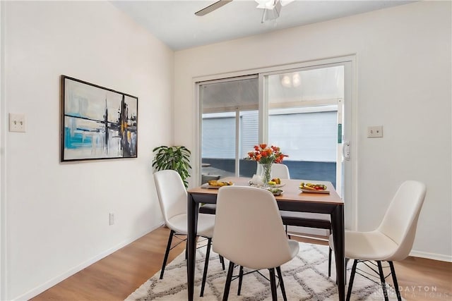 dining area featuring ceiling fan, wood finished floors, and baseboards