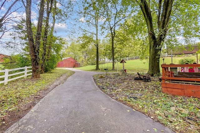 view of home's community with fence and a lawn