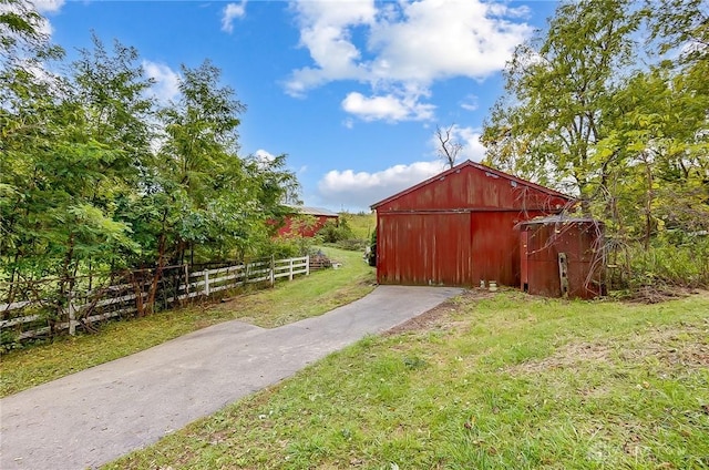 view of pole building with a yard and fence