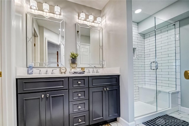 bathroom with baseboards, double vanity, a sink, and a shower stall