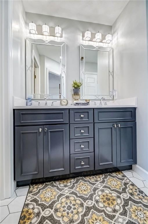 bathroom with a sink, double vanity, and tile patterned flooring