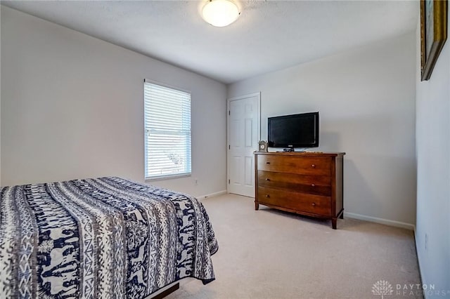 bedroom with carpet and baseboards