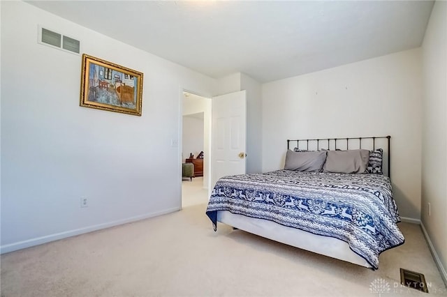 carpeted bedroom featuring visible vents and baseboards