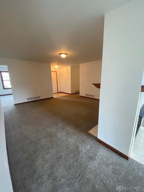 carpeted spare room featuring visible vents