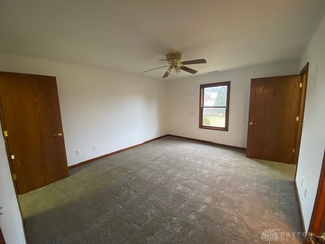 unfurnished bedroom featuring carpet floors, a ceiling fan, and baseboards