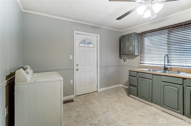 washroom featuring cabinet space, baseboards, a ceiling fan, ornamental molding, and a sink