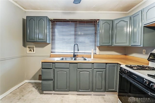 kitchen with gray cabinetry, a sink, and range with gas stovetop